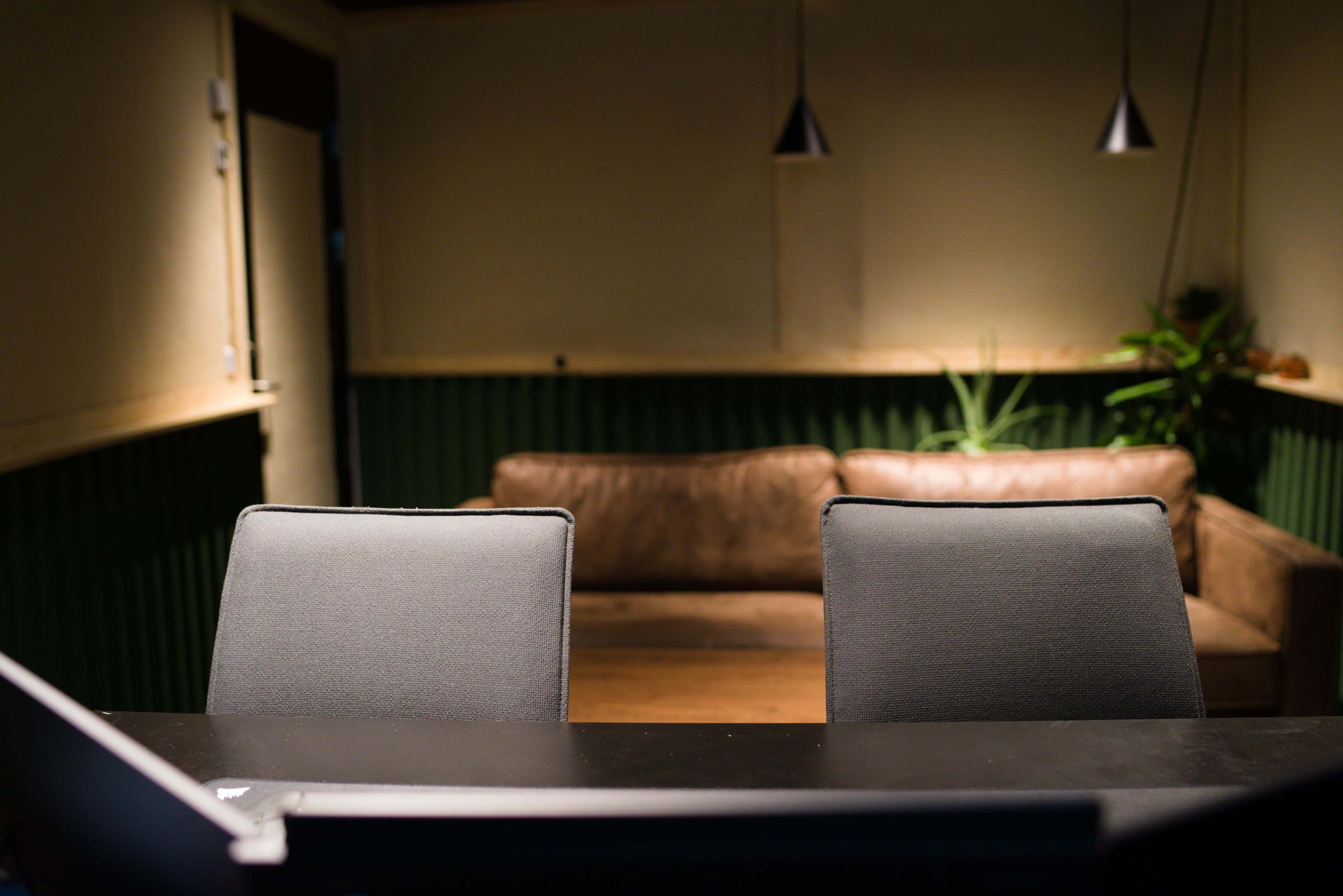Control room with desk chairs and lounge area